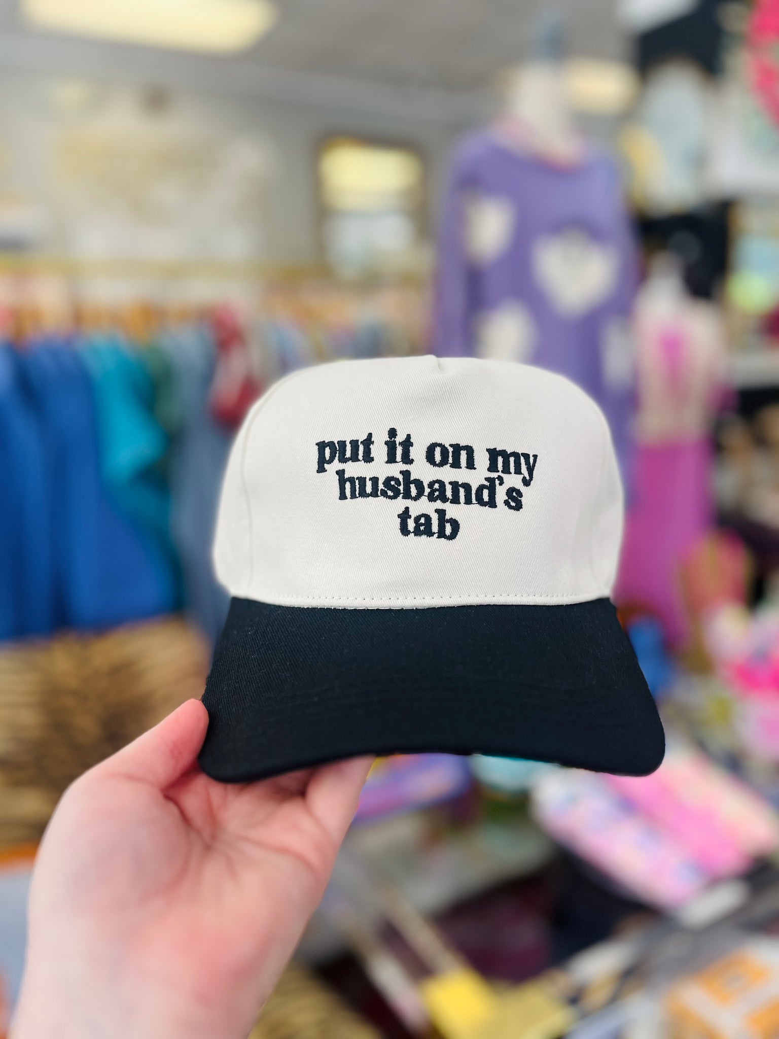 Put It On My Husbands Tab Trucker Hat - Black